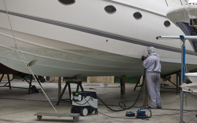 man cleaning a big boat