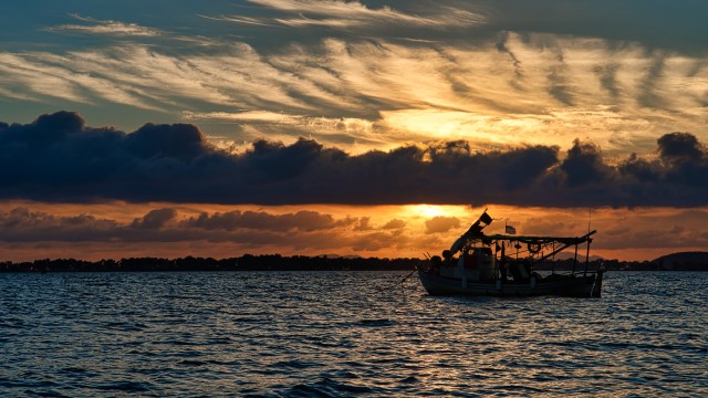 sunset with a boat in the background
