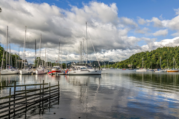 Sailboats in harbor at Windermere at Bowness on sunny day.
