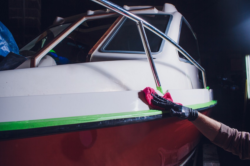 person cleaning a boat