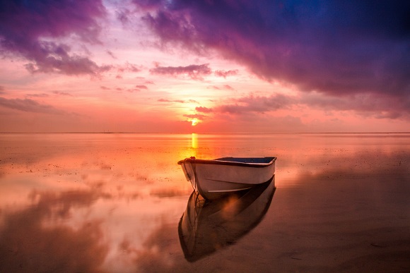 gorgeous sunset boat on still waters
