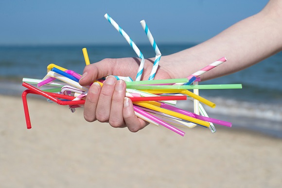 handful of bad plastic straws on the beach