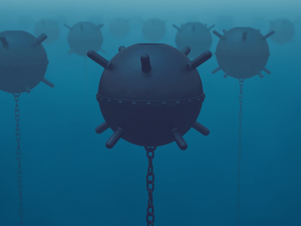 A field of naval mines in the sea (latent threat)