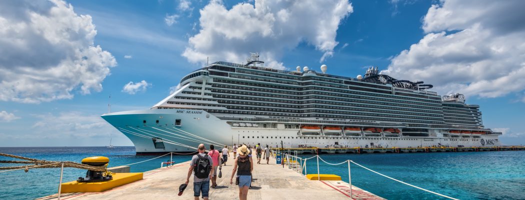 Cruise passengers arrive to the cruise ship to check in and board the MSC Seaside Cruise Ship which sails from Cozumel to Miami.