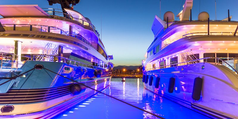 two yacht parked at night with lights