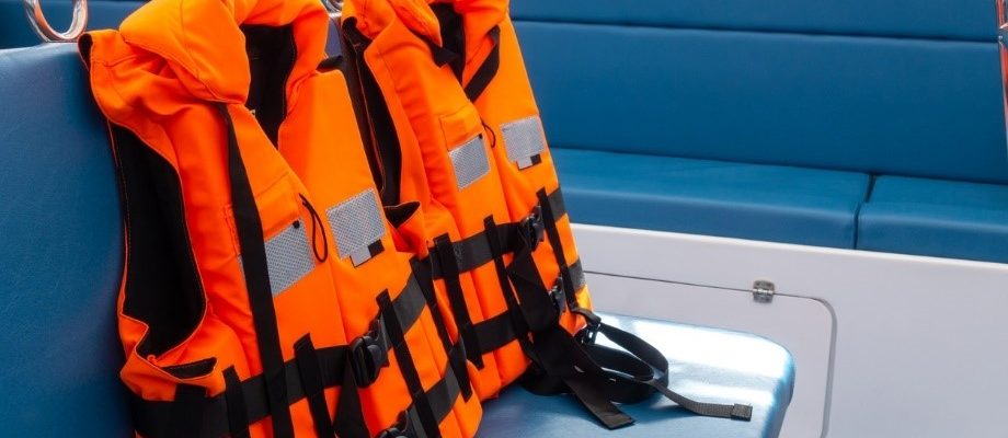 A group of orange life jackets, one of the most important boat accessories.