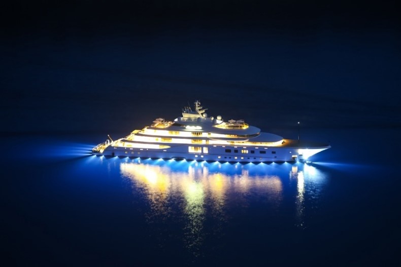 A large yacht lit up at night