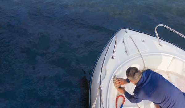 Overhead photograph of a man cleaning a yacht