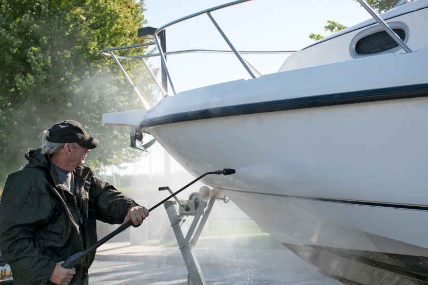 man jet washing his boat