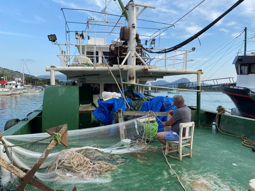 A person sitting on a chair on a boat