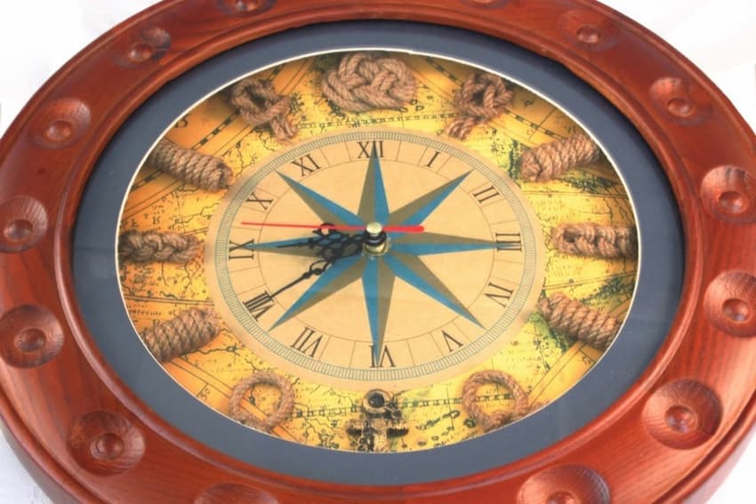A clock with a compass and rope around it