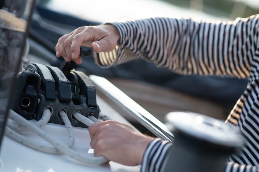 A person connecting a switch to a boat