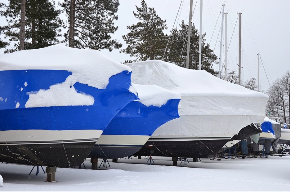 Boats covered in snow on a dock