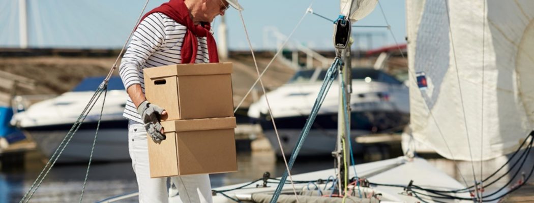 boat captain carrying a box