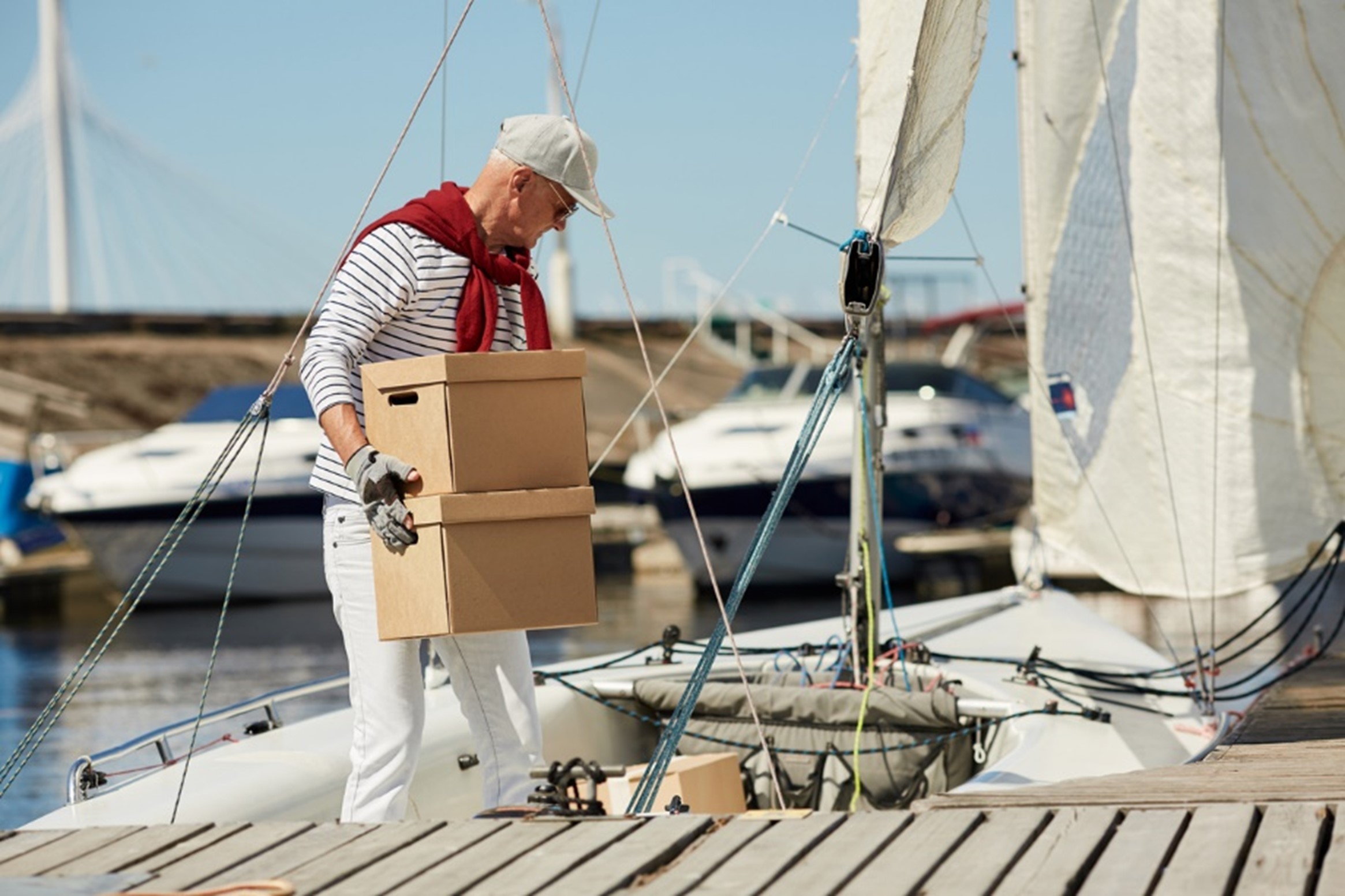 boat captain carrying a box
